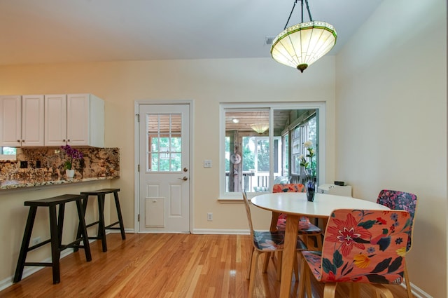 dining area with light wood-style flooring and baseboards
