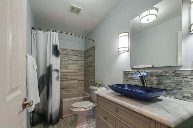 bathroom featuring tasteful backsplash, shower / bathtub combination with curtain, vanity, visible vents, and toilet