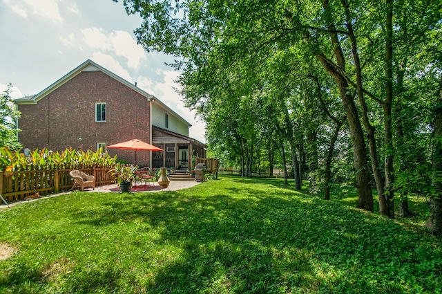 view of yard with fence, a patio, and a wooden deck