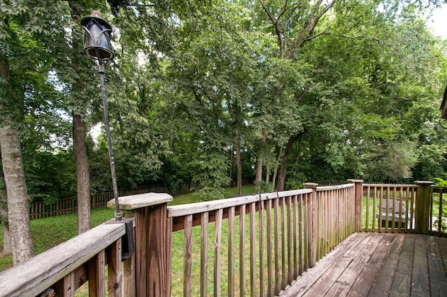 wooden terrace with fence and a lawn