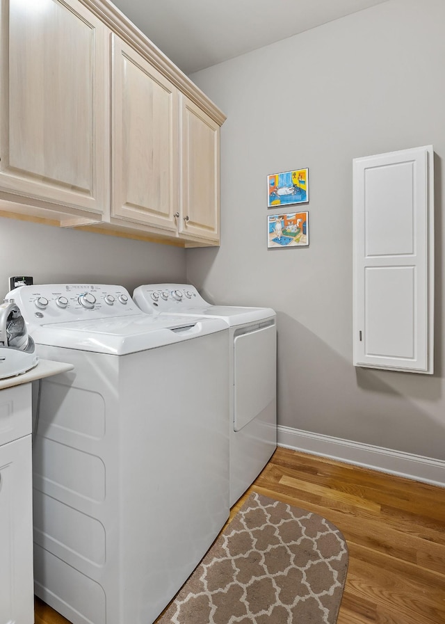 134 Joe Blanton Rd, Woodbury, TN 37190 - washroom featuring separate washer and dryer, baseboards, cabinet space, and wood finished floors