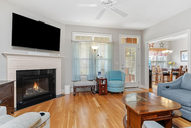 134 Joe Blanton Rd, Woodbury, TN 37190 - living area featuring a glass covered fireplace, light wood finished floors, and ceiling fan