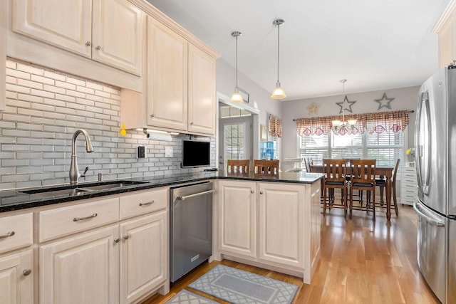 134 Joe Blanton Rd, Woodbury, TN 37190 - kitchen featuring a sink, appliances with stainless steel finishes, a peninsula, backsplash, and light wood-style flooring