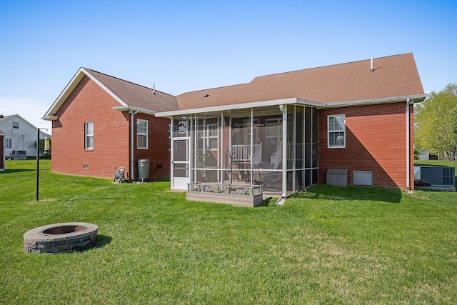 134 Joe Blanton Rd, Woodbury, TN 37190 - back of property with brick siding, a fire pit, a yard, and a sunroom