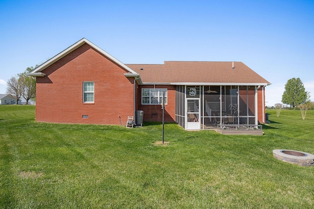134 Joe Blanton Rd, Woodbury, TN 37190 - back of property featuring a sunroom, crawl space, a yard, a fire pit, and brick siding
