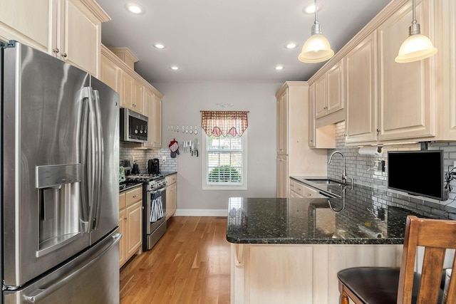 134 Joe Blanton Rd, Woodbury, TN 37190 - kitchen featuring a sink, decorative backsplash, light wood-style flooring, appliances with stainless steel finishes, and recessed lighting