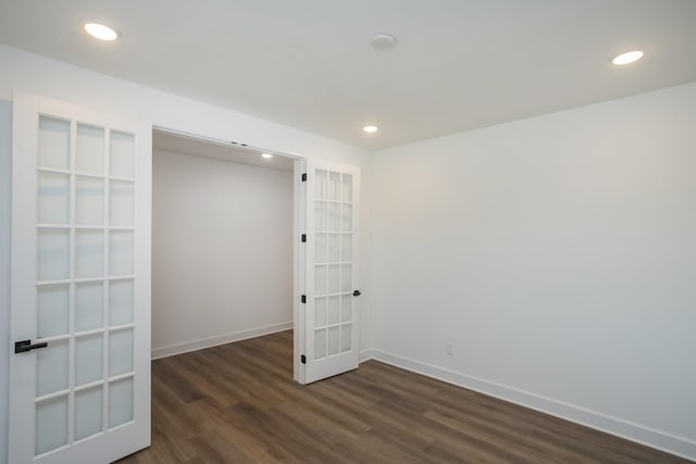unfurnished room featuring recessed lighting, dark wood-style flooring, french doors, and baseboards