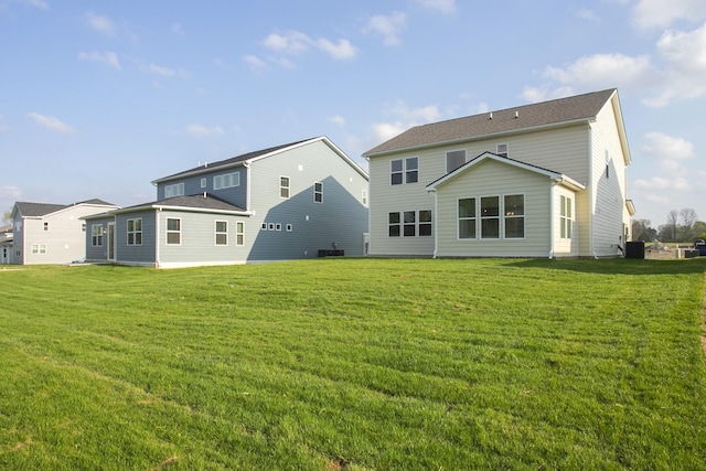 rear view of house with a yard