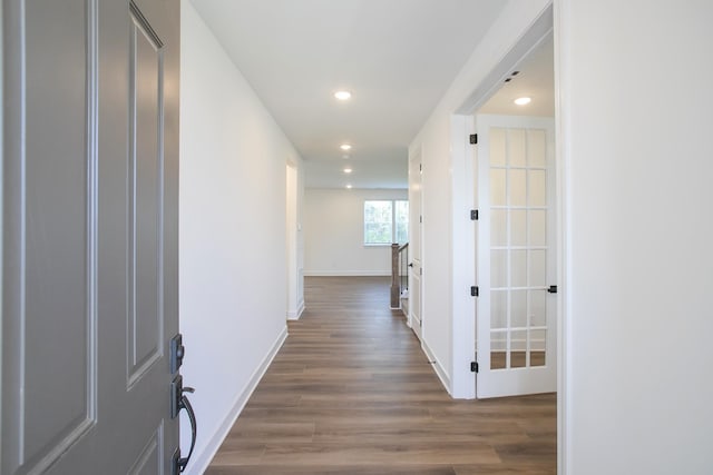 hall with wood finished floors, recessed lighting, and baseboards