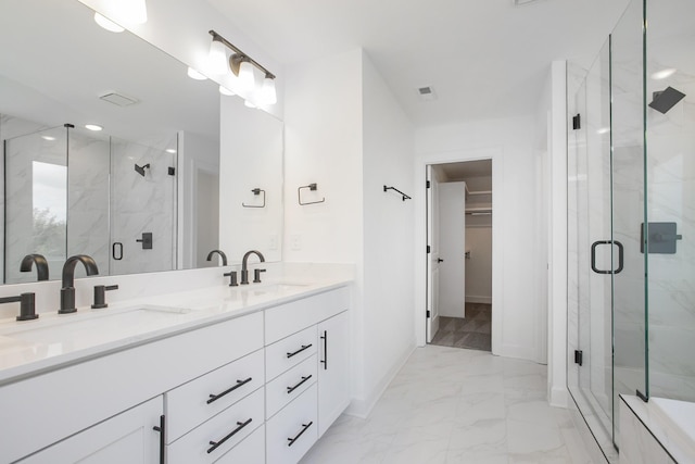 bathroom with a marble finish shower, marble finish floor, and a sink
