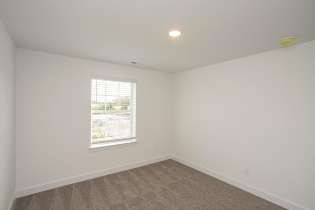 empty room with carpet floors, recessed lighting, and baseboards