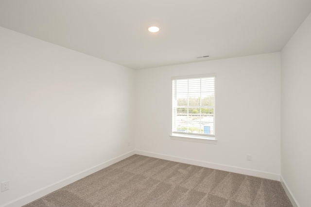 empty room with baseboards, visible vents, light colored carpet, and recessed lighting