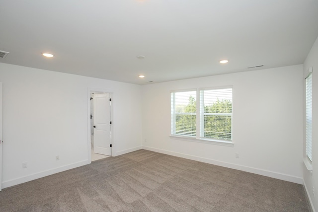 unfurnished room featuring carpet, recessed lighting, and baseboards