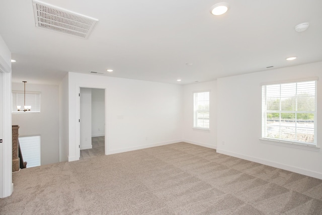unfurnished room with a notable chandelier, recessed lighting, visible vents, and light colored carpet