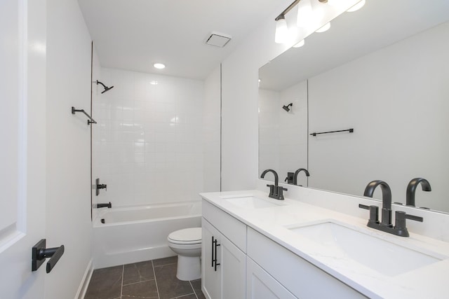 bathroom with shower / bathing tub combination, toilet, double vanity, and a sink