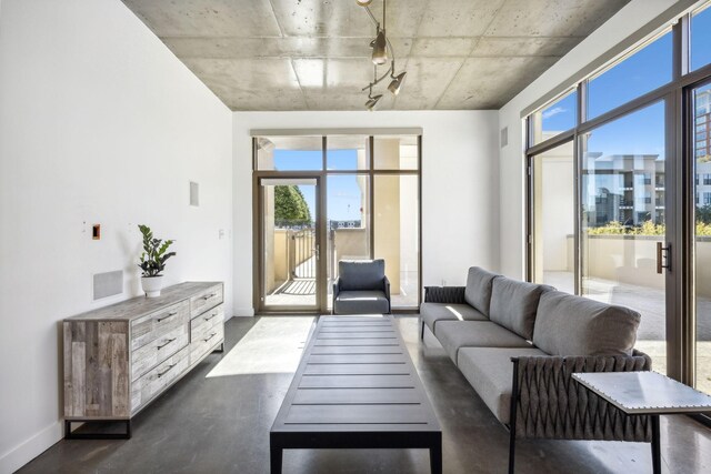 1510 Demonbreun St Unit 511, Nashville, TN 37203 - living area featuring rail lighting, plenty of natural light, and baseboards