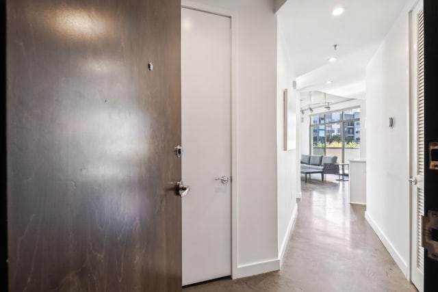 1510 Demonbreun St Unit 511, Nashville, TN 37203 - corridor featuring baseboards, concrete flooring, and recessed lighting