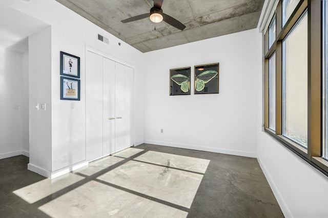 1510 Demonbreun St Unit 511, Nashville, TN 37203 - unfurnished bedroom featuring finished concrete flooring, a closet, baseboards, and ceiling fan