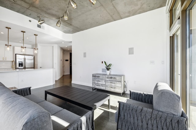 1510 Demonbreun St Unit 511, Nashville, TN 37203 - living room with finished concrete flooring and baseboards