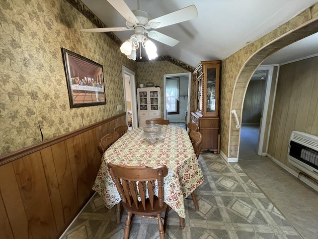 312 Neal St, Huntland, TN 37345 - dining area with arched walkways, a ceiling fan, vaulted ceiling, wood walls, and heating unit