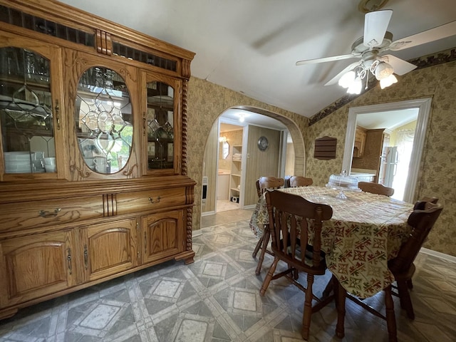 312 Neal St, Huntland, TN 37345 - dining room with baseboards, wallpapered walls, a ceiling fan, lofted ceiling, and arched walkways