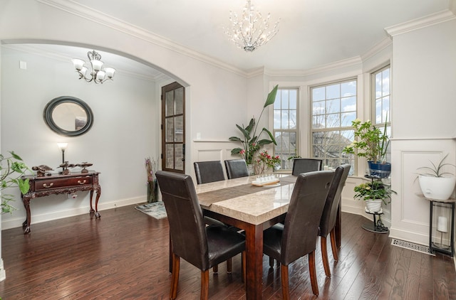 5344 Highland Place Way, Hermitage, TN 37076 - dining room featuring a chandelier, arched walkways, dark wood finished floors, ornamental molding, and baseboards