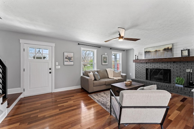 living area featuring a healthy amount of sunlight, ceiling fan, and wood finished floors