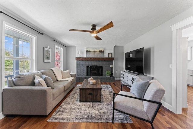 living room with wood finished floors and a ceiling fan