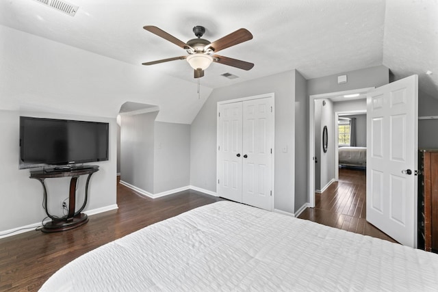 bedroom with visible vents, baseboards, wood finished floors, and lofted ceiling