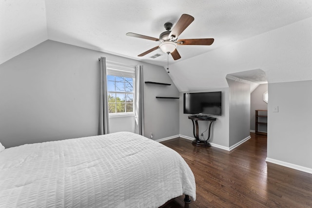 bedroom featuring ceiling fan, baseboards, wood finished floors, and lofted ceiling