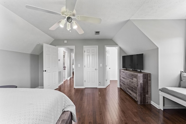 bedroom with visible vents, baseboards, a ceiling fan, hardwood / wood-style flooring, and vaulted ceiling