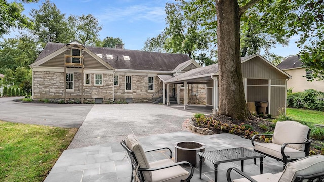 931 Caldwell Ln, Nashville, TN 37204 - rear view of property with an outdoor fire pit, a patio area, and stone siding