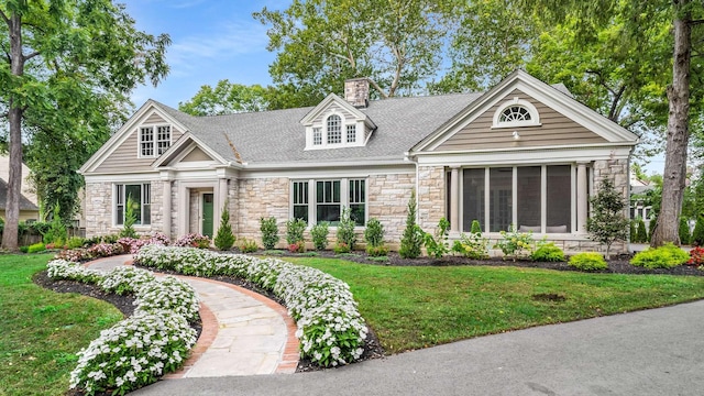 931 Caldwell Ln, Nashville, TN 37204 - view of front of property featuring a sunroom, a chimney, stone siding, and a front lawn
