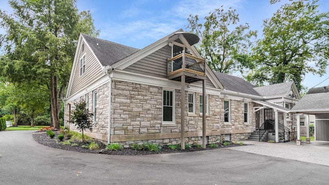 931 Caldwell Ln, Nashville, TN 37204 - view of property exterior featuring aphalt driveway, a shingled roof, stone siding, and a balcony
