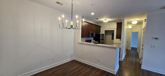 8047 Bienville Dr Unit X6, Nashville, TN 37211 - kitchen featuring stainless steel microwave, light countertops, dark wood-style floors, a chandelier, and recessed lighting