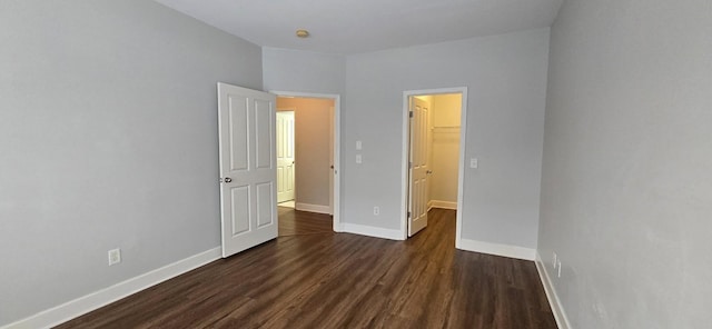 8047 Bienville Dr Unit X6, Nashville, TN 37211 - unfurnished bedroom with dark wood-style floors, a walk in closet, baseboards, and a closet