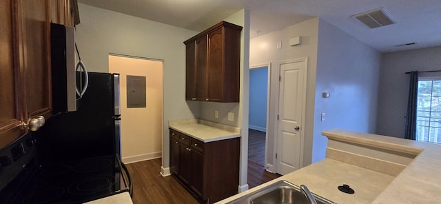 8047 Bienville Dr Unit X6, Nashville, TN 37211 - kitchen with black electric range oven, dark wood-style floors, light countertops, dark brown cabinets, and electric panel