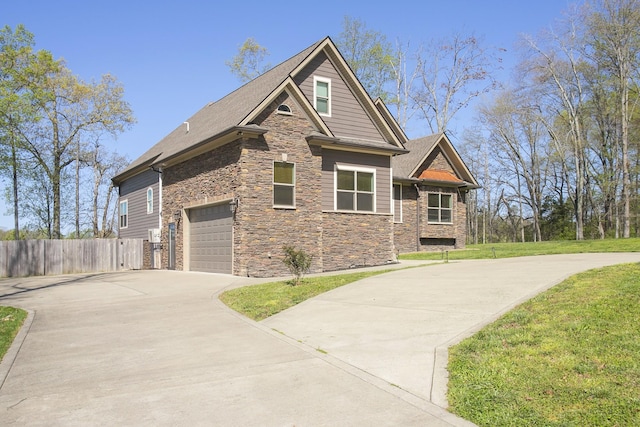4512 General Forest Cir, Bon Aqua, TN 37025 - craftsman inspired home with an attached garage, stone siding, fence, a front lawn, and driveway