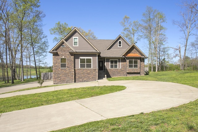 4512 General Forest Cir, Bon Aqua, TN 37025 - craftsman-style home featuring curved driveway, stone siding, and a front lawn