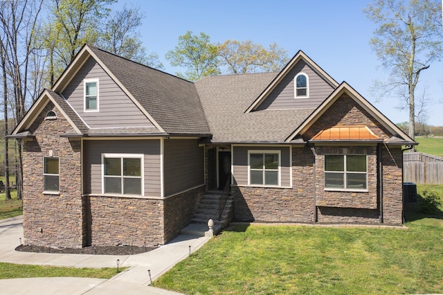 4512 General Forest Cir, Bon Aqua, TN 37025 - craftsman-style house with central air condition unit, a front yard, fence, stone siding, and a shingled roof