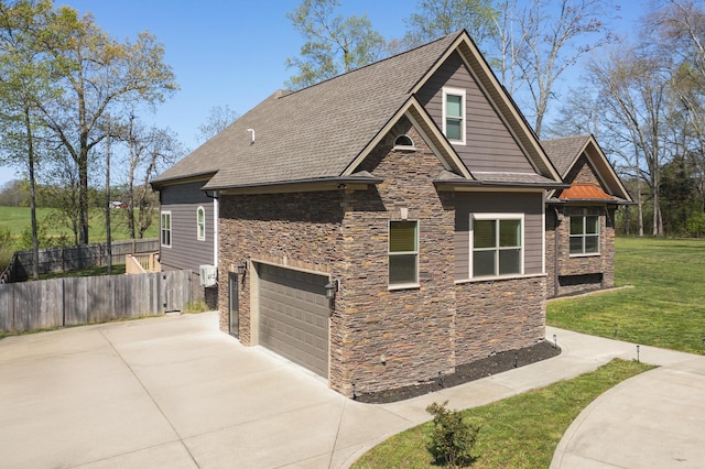4512 General Forest Cir, Bon Aqua, TN 37025 - view of property exterior with a yard, fence, stone siding, an attached garage, and driveway