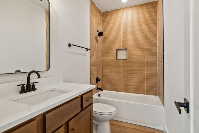 full bath featuring toilet, shower / bath combination, wood finished floors, and vanity
