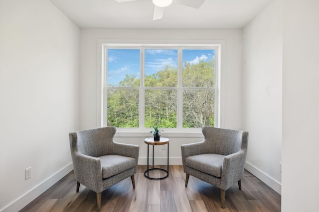 sitting room with plenty of natural light, baseboards, and wood finished floors