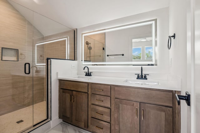 bathroom with a stall shower, double vanity, a sink, and vaulted ceiling