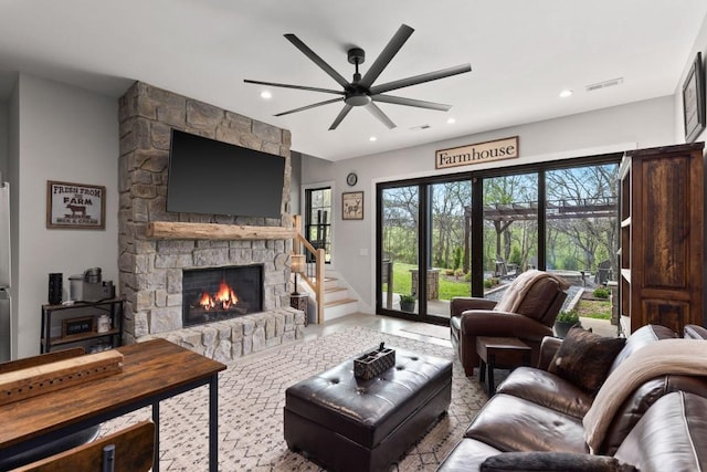 living room with ceiling fan, a fireplace, visible vents, and recessed lighting
