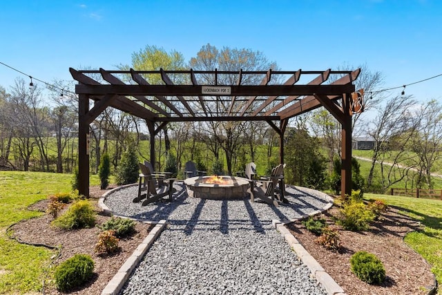 view of home's community featuring a pergola, a patio area, an outdoor fire pit, and a lawn
