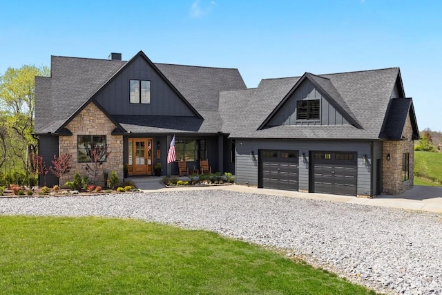 view of front facade with board and batten siding, a shingled roof, and stone siding