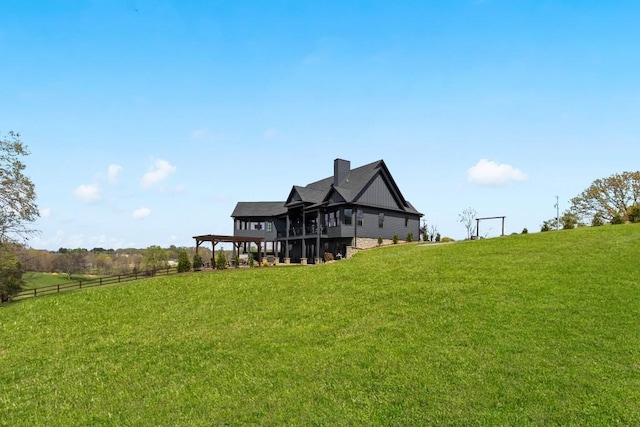 back of house with a lawn