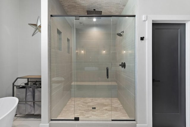 bathroom with a sauna, a freestanding bath, and a stall shower