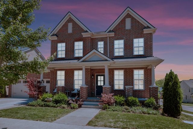 779 Newcomb St, Franklin, TN 37064 - view of front facade with brick siding, covered porch, concrete driveway, and a front lawn